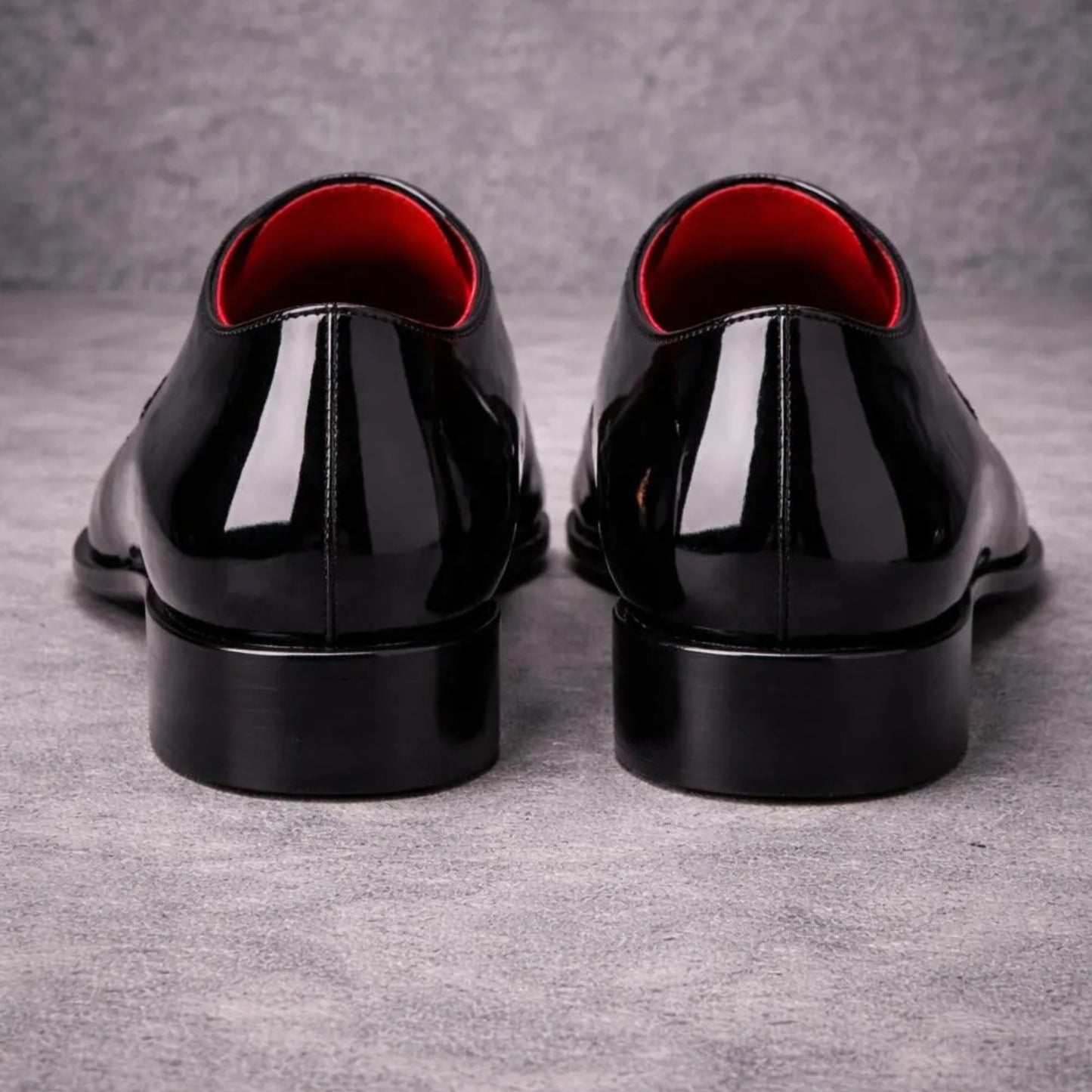 Pair of black dress shoes with red lining