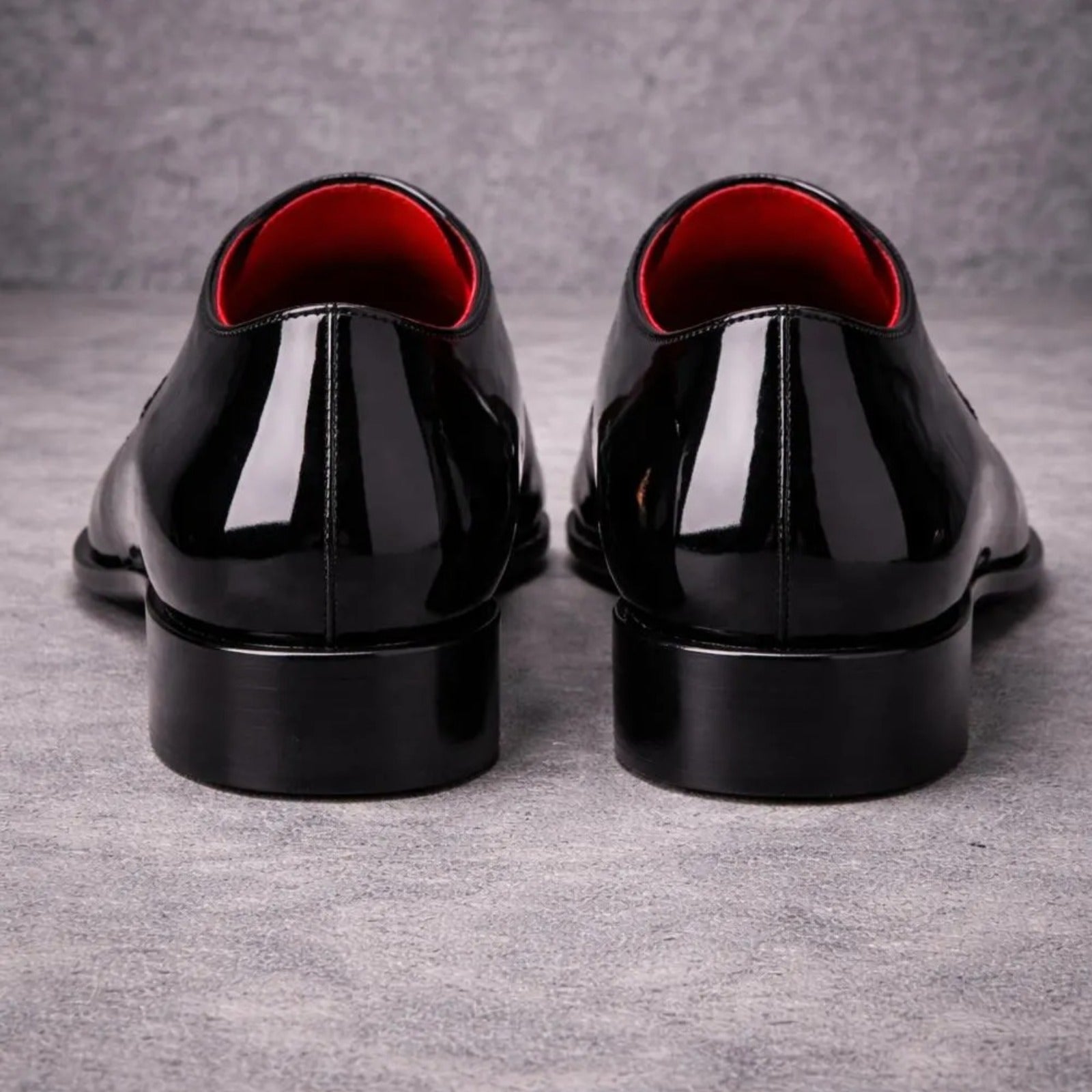 Pair of black dress shoes with red lining