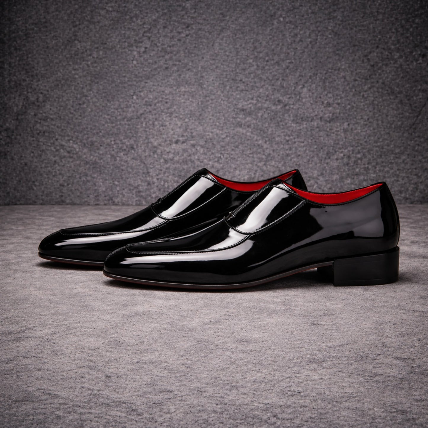 Pair of black patent leather shoes with red lining